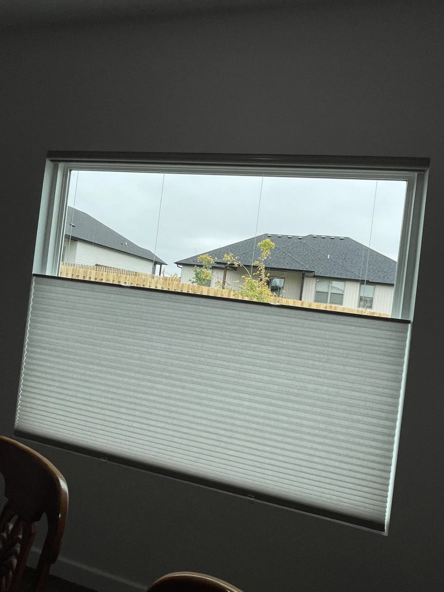 Cellular shades on a window opening from the top