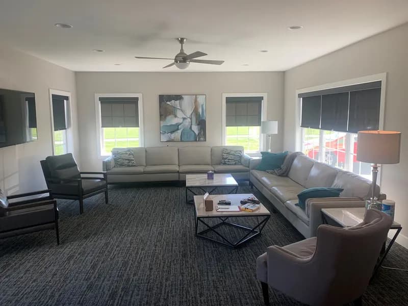 A living room filled with furniture and a ceiling fan.